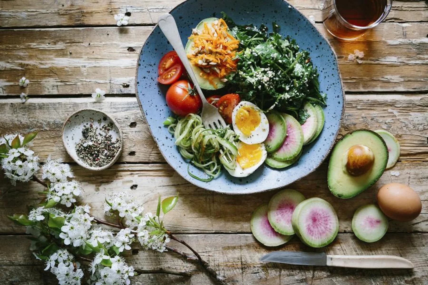 A spread of fresh, natural plant-based ingredients laid out on a wooden table.