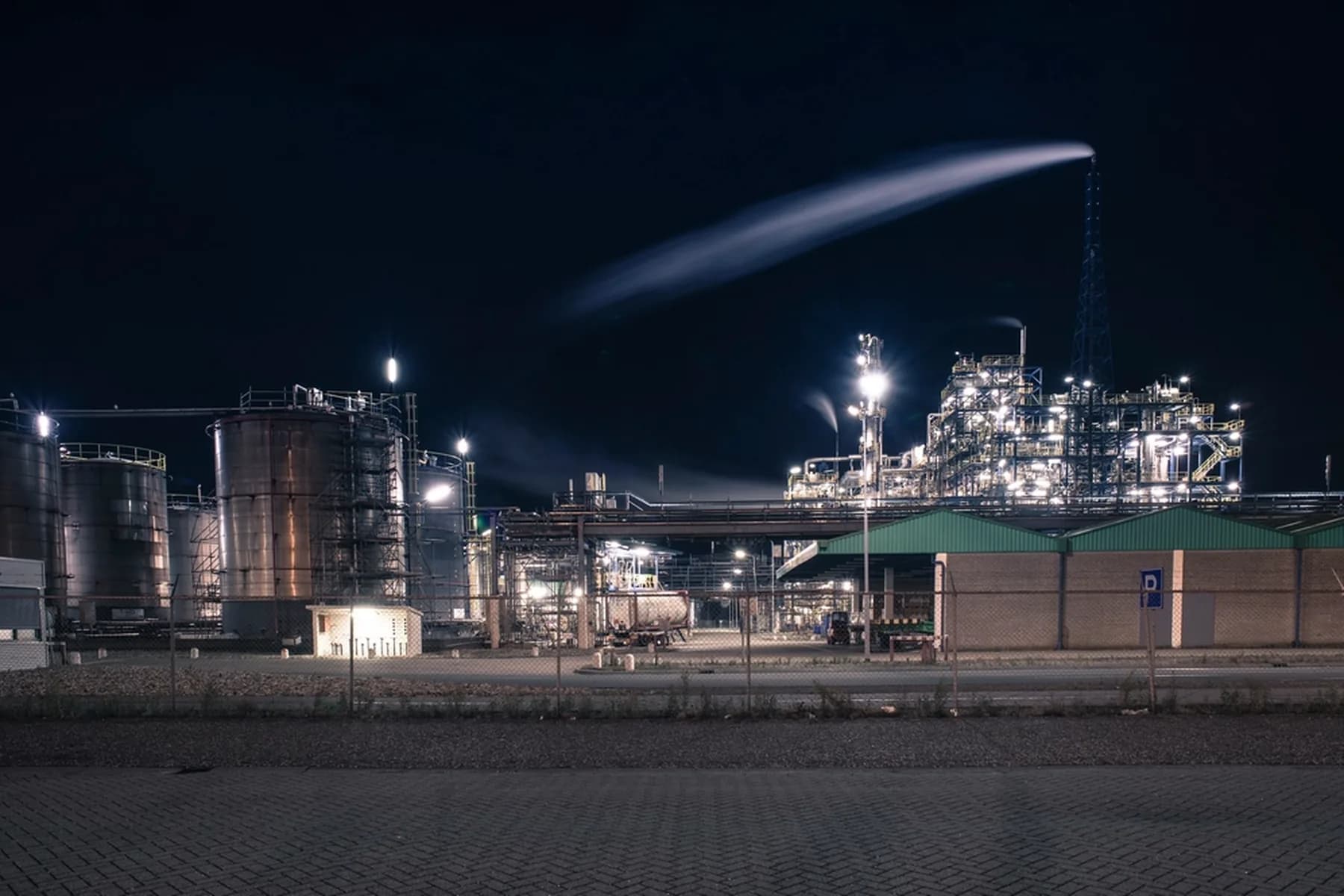 An industrial processing plant lit up against the night sky.